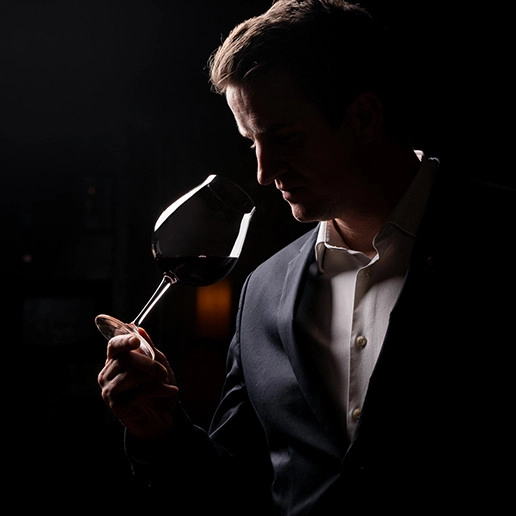 Man smelling a glass of wine at the Dans le Noir ? restaurant